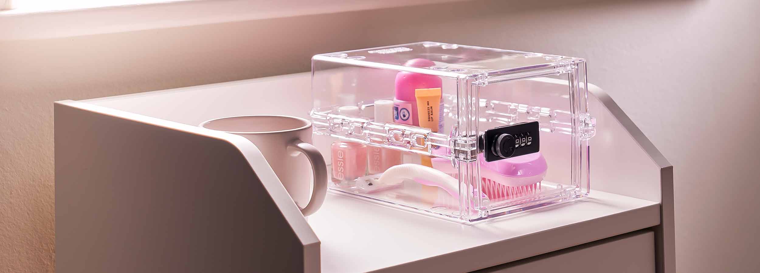 Lockabox Lock box on a chest of drawers next to a mug