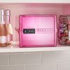 Pink food safe on kitchen shelf with prosecco and chocolates