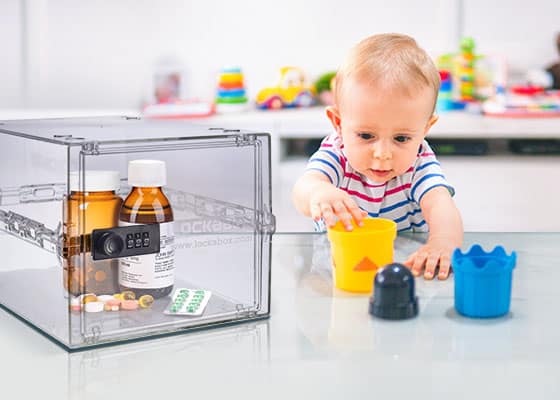 Medicine locked away in a medication lock box while a child plays in a kitchen