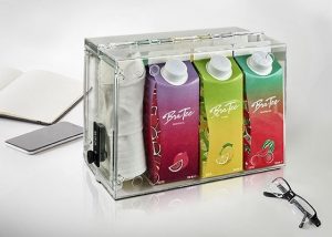 Clear lock box filled with juice boxes and hat to promote new drinks brand.